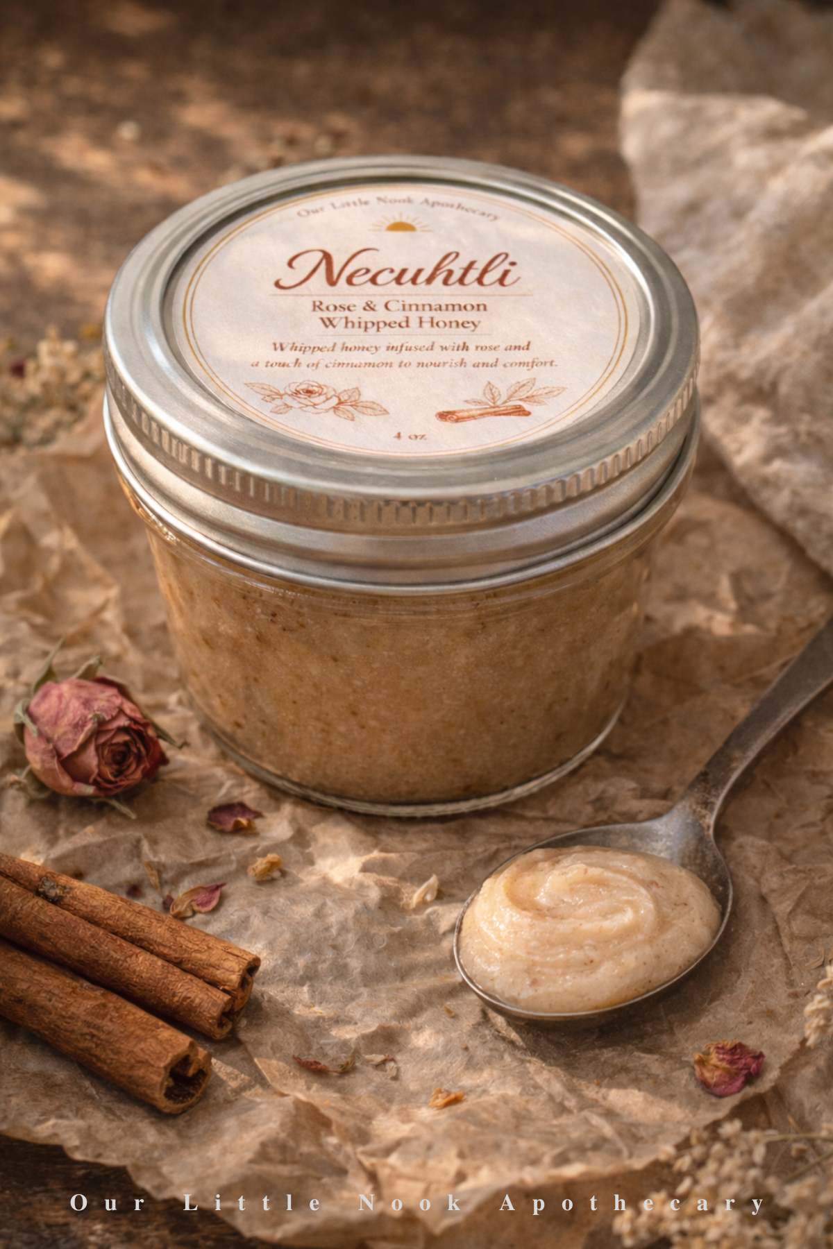 Jar of Necuhtli, rose and cinnamon whipped honey with a spoonful on a rustic background.